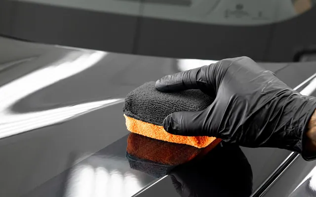 Ceramic coating applied by hand to glossy black paint