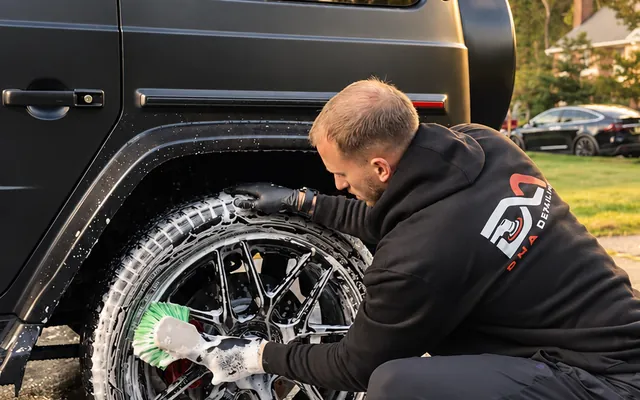 Andrew scrubbing a G63 wheel at sunset