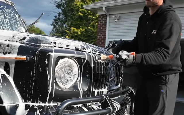 A detailing brush worked through the foamed front grille
