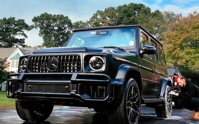 Andrew washing the wheels of a G63 in the driveway