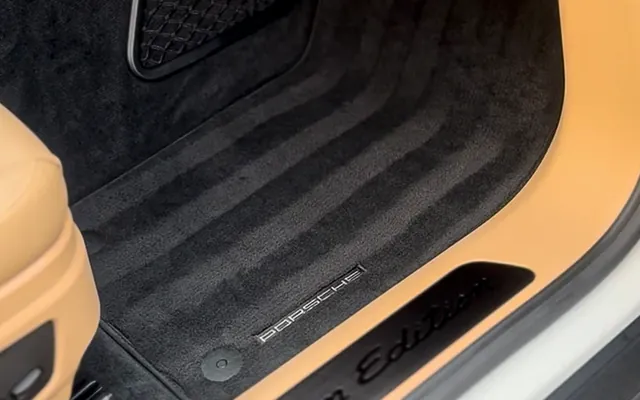 Clean tan carpet and mats in a Porsche Carrera after an interior detail