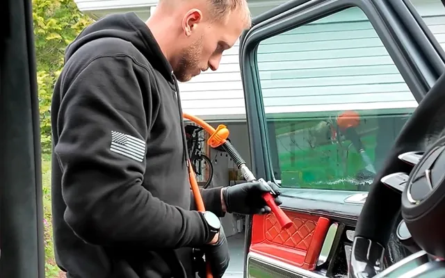 Andrew vacuuming and drying the interior of a Mercedes G63