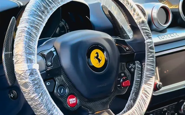 A Ferrari California cabin after an interior detail, steering wheel protected