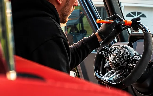Andrew brushing the steering wheel crevices of a G63