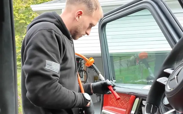 Andrew cleaning the interior of the G63 with the doors open
